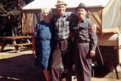 Tracie, Allen, and Daniel Arnold with camper by lake, October 1970.