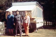 Tracie, Daniel, and Eleanor Arnold with camper by lake, October 1970.