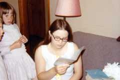 Teresa and Valerie watch Joyce open gifts after baccalaureate, June 1971.