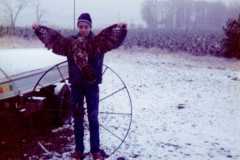 Dan with hawk shot by grandpa Dan, and wagon wheel found in woods, deer season at the Arnold homestead. November 1972.