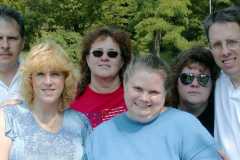 Children of Laban Arnold and Doris Moore meet at Platte Cemetery to hold burial service, September 2002.